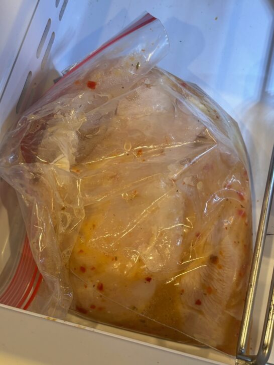 Simple grilled chicken breast marinating in refrigerator