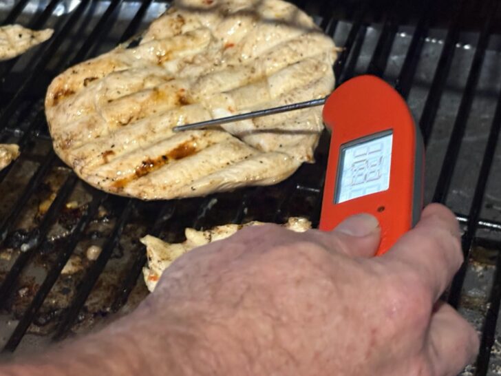 chicken breast on the grill with temperature gauge