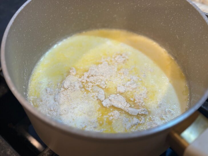 Easy Homemade Alfredo Sauce on stove with flour added to thicken