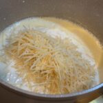 Easy Homemade Alfredo Sauce on stove, parmesan added