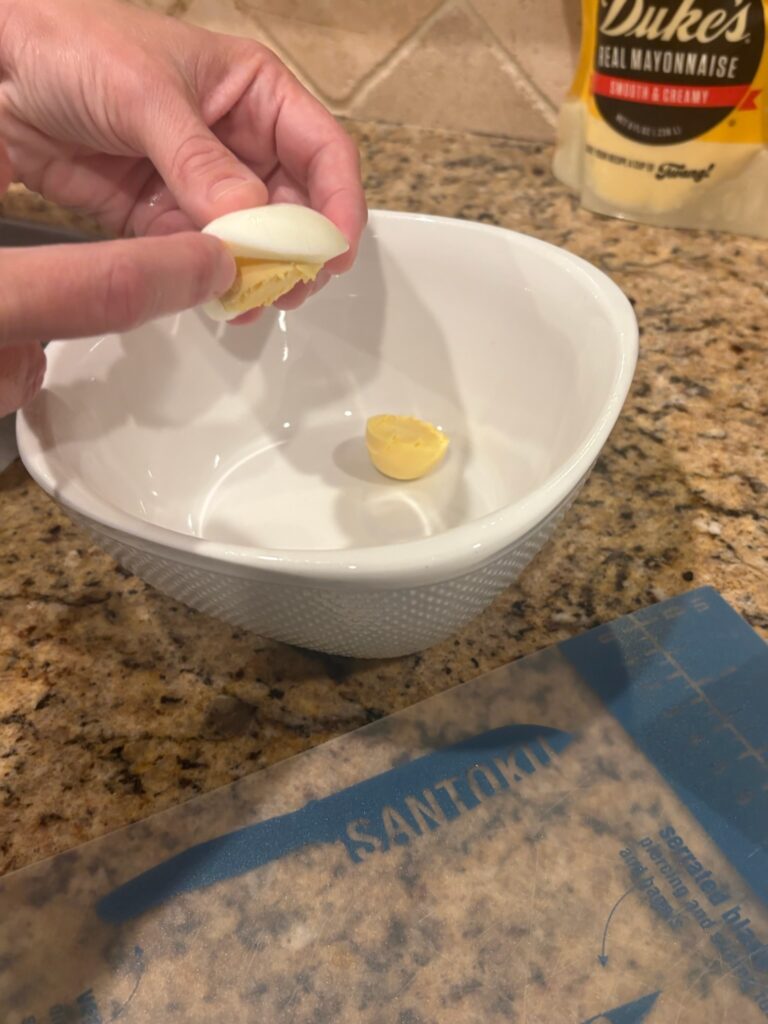 releasing the yolk from cooked egg