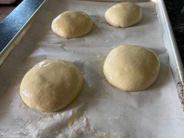 risen buns with egg wash