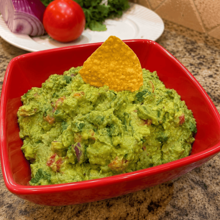 finished guacamole in red bowl