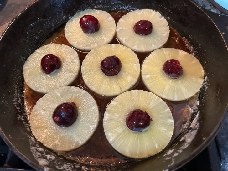 pineapple rings in the bottom of a cast iron skillet
