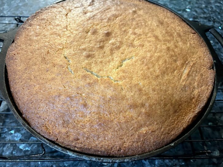 pineapple upside-down cake in cast iron skillet before flipping