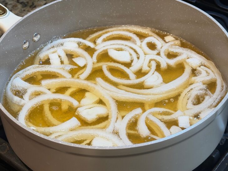 simmering onions and liquids in pan