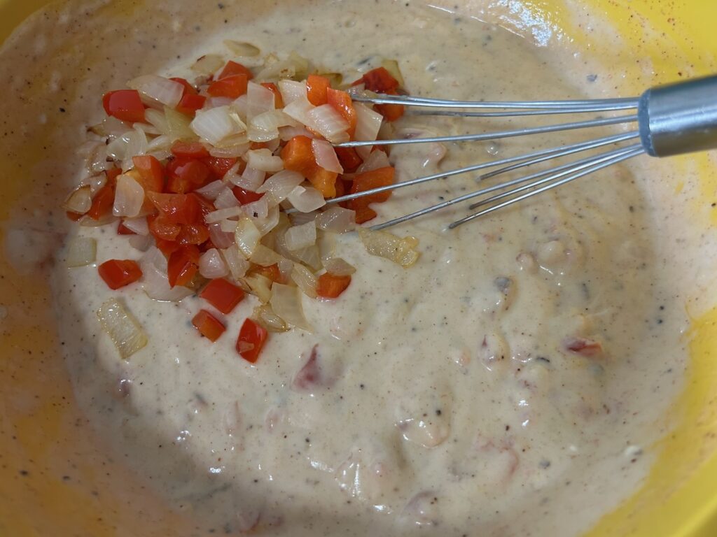 Easy King Ranch Chicken (Texas Style) sauce in bowl with peppers and onions