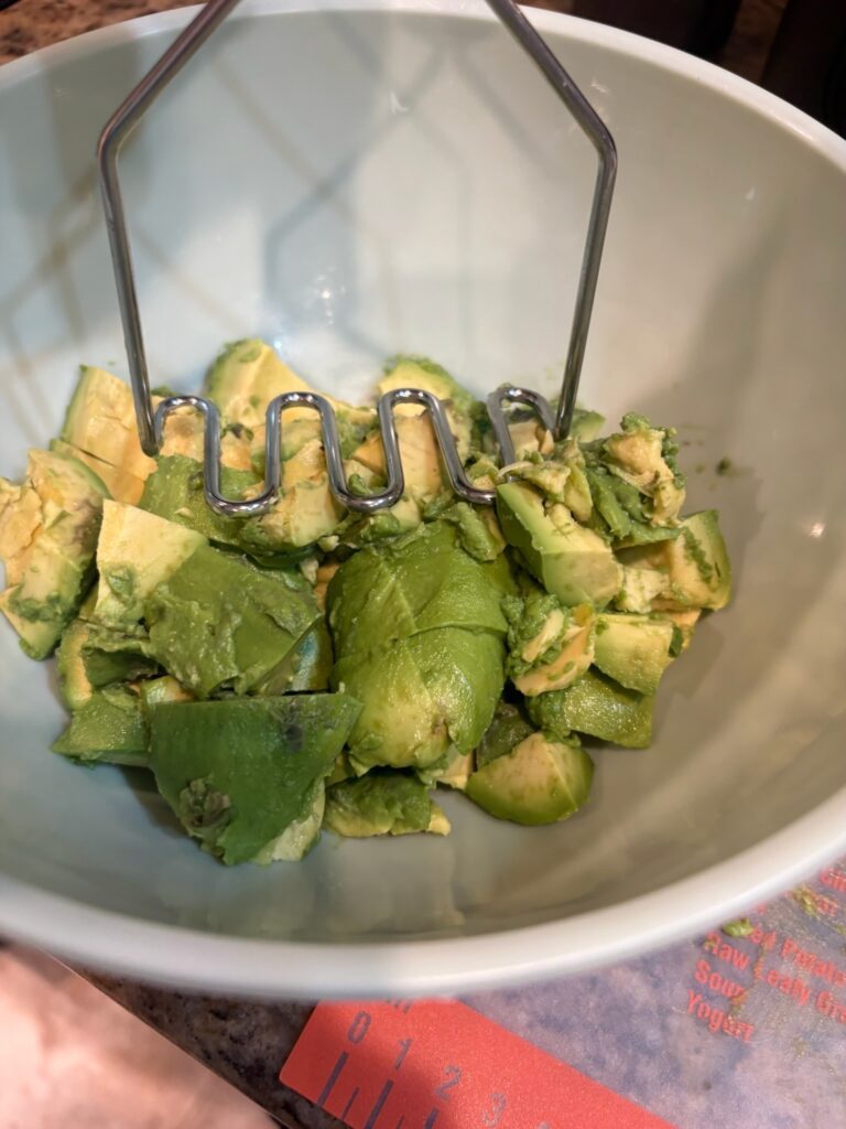 mashing avocado