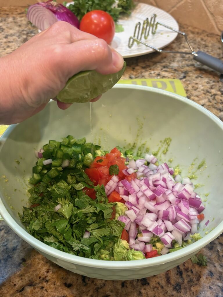 adding lime and spices to veggies