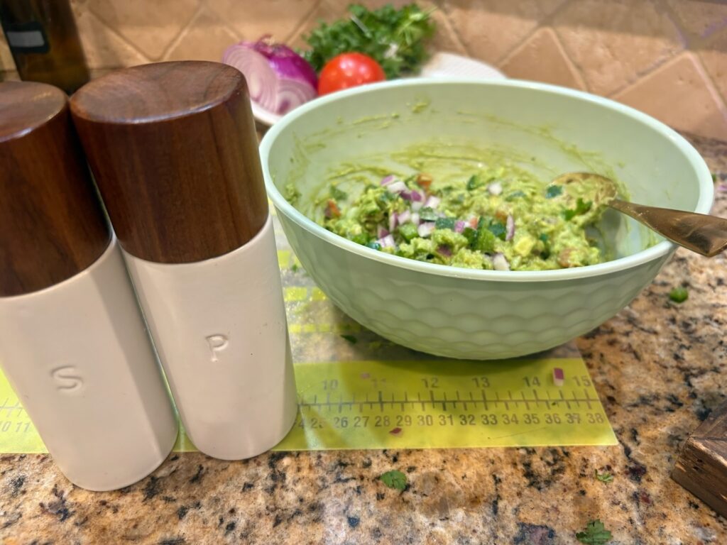 adding spices to guacamole
