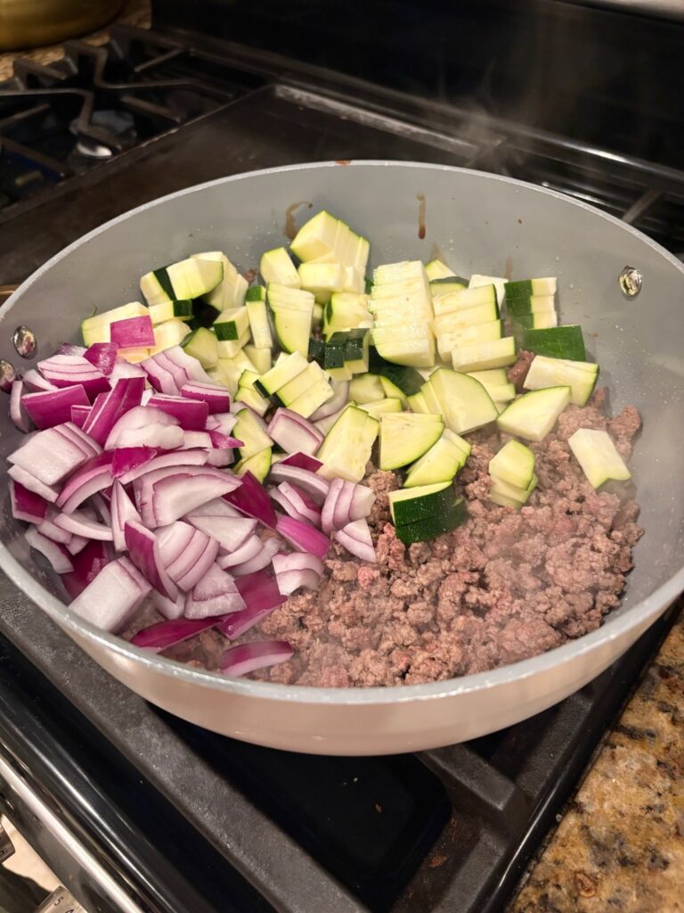 Creamy High Protein Beef and Zucchini Pasta ingredients in pan