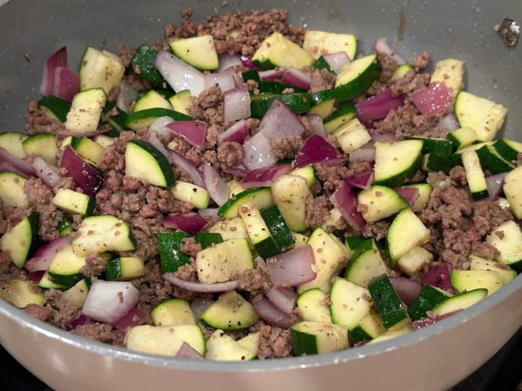 Creamy High Protein Beef and Zucchini Pasta ingredients in pan