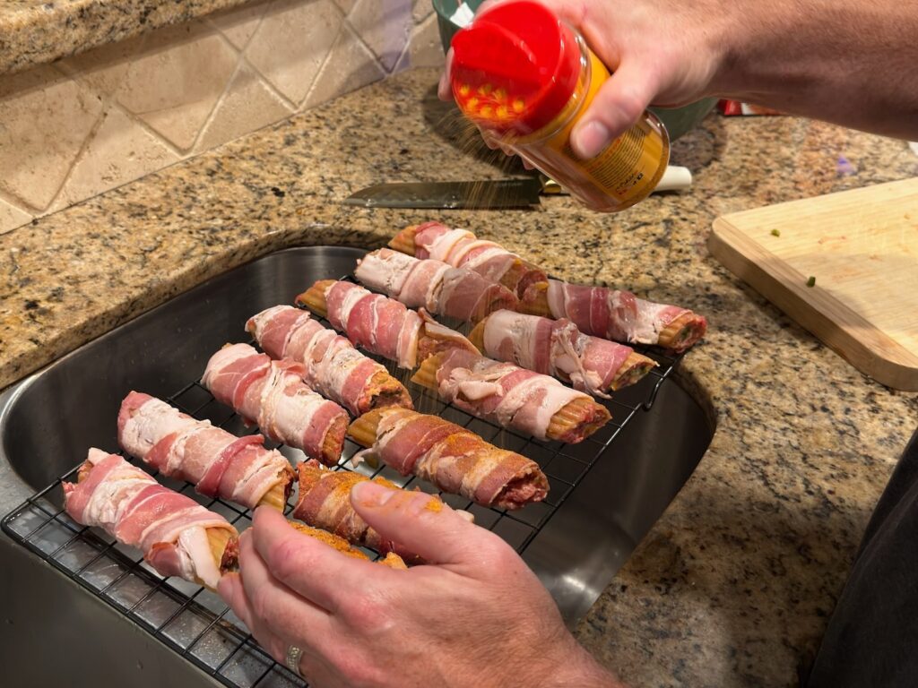 Smoked Shotgun Shells (Bacon-Wrapped Manicotti) adding seasoning