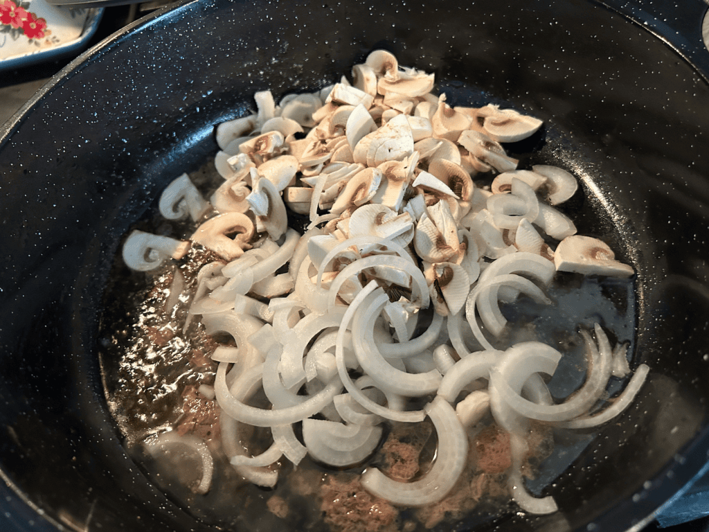 onions and mushrooms in skillet