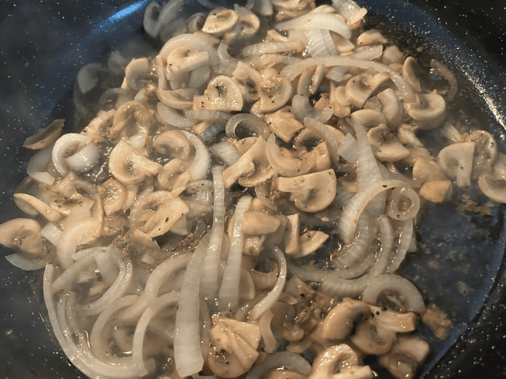 onions and mushrooms in skillet