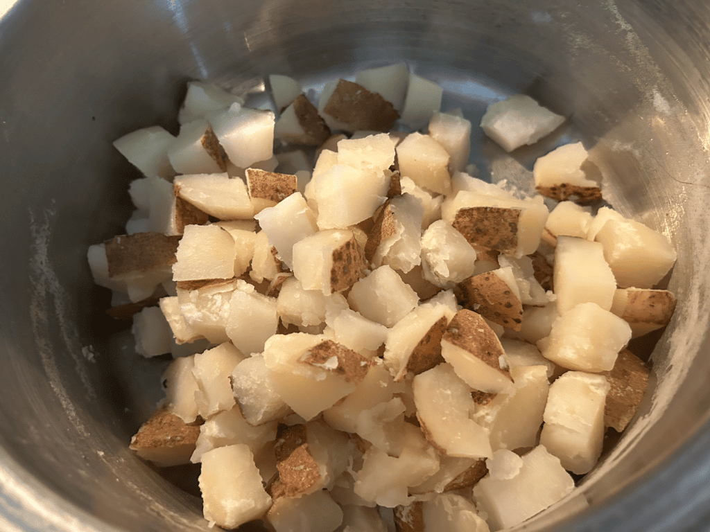 cooked cubed potatoes in pan