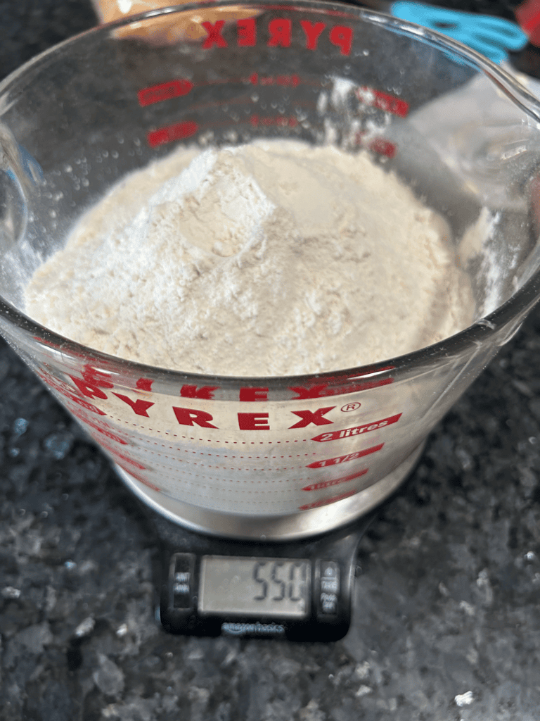 adding flour to bread recipe