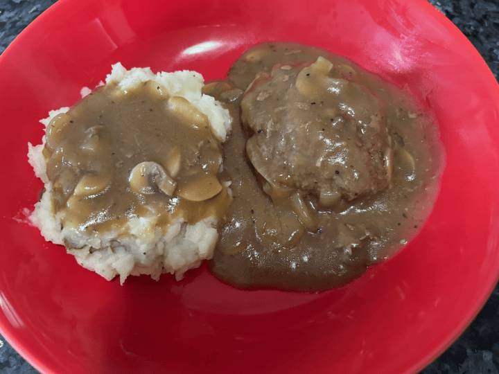 Easy Salisbury Steak with Mushroom Gravy alongside mashed potatoes