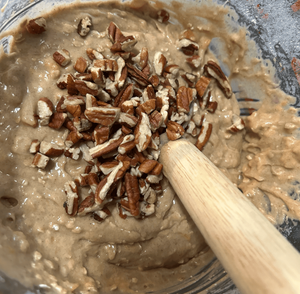 Easy Peach Streusel Muffin batter in bowl with pecans