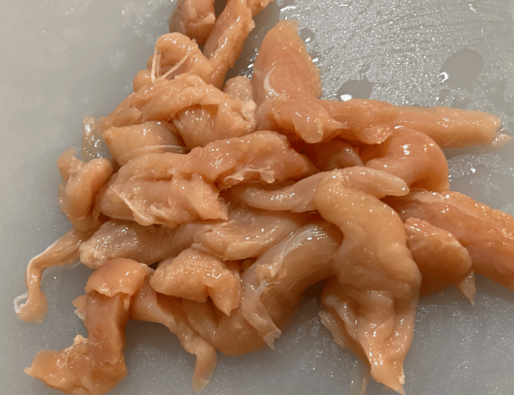 raw chicken breast on cutting board