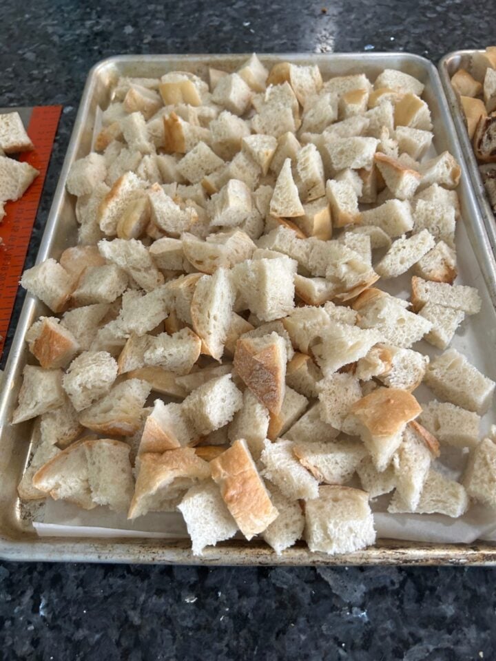cubed dried bread on cookie sheet