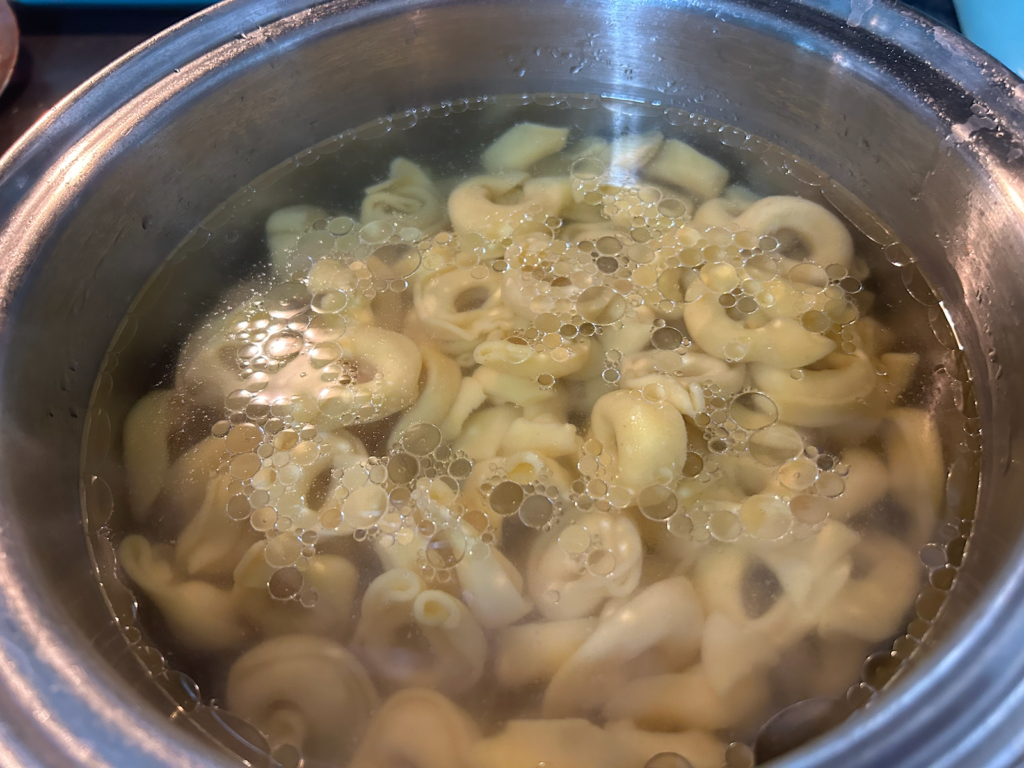tortellini boiling in pan