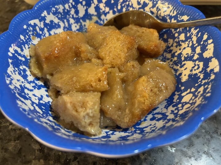 Old-Fashioned Bread Pudding with Brown Sugar Vanilla Sauce in bowl with spoon
