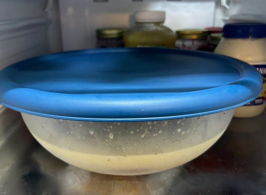 chicken breast soaking in milk, refrigerated in sealed bowl