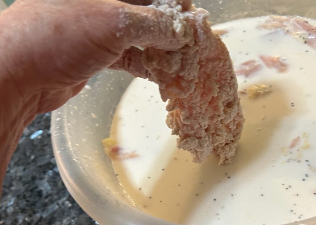 coating dredged chicken in milk