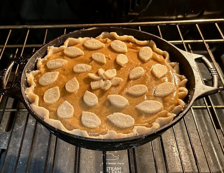 Old Fashioned Cast Iron Pumpkin Pie in oven