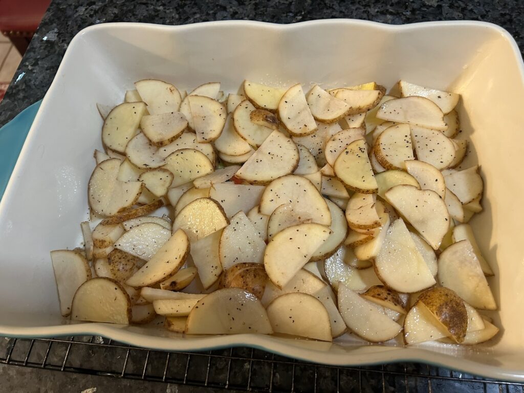 sliced potatoes in casserole dish