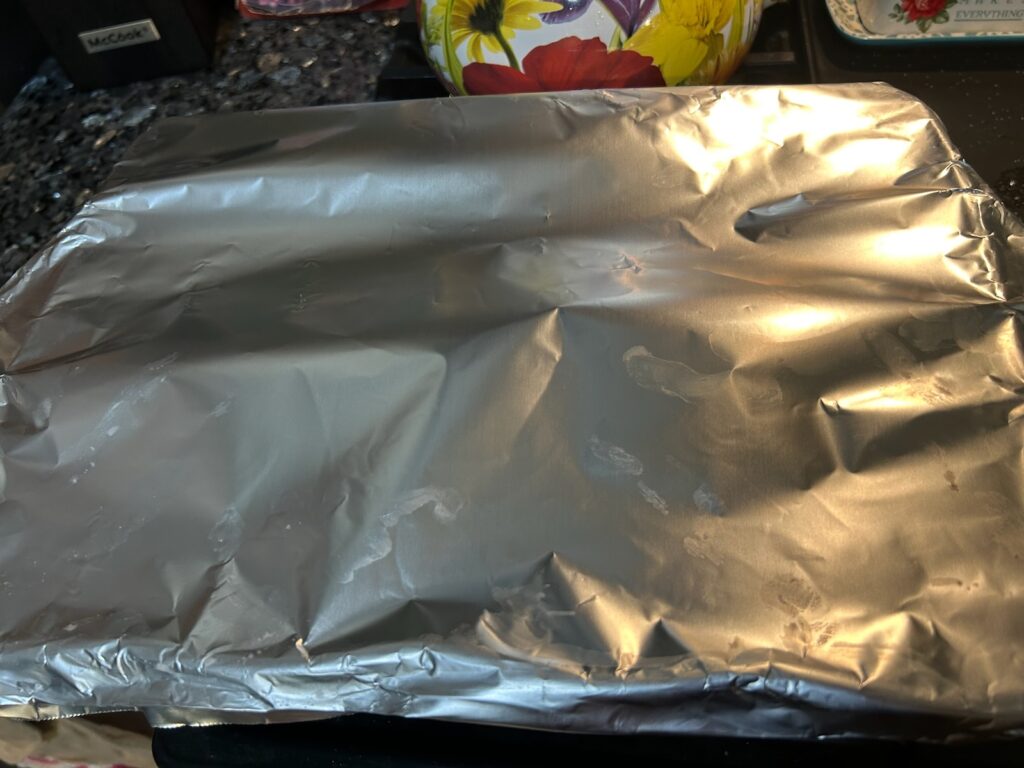 Old-Fashioned Creamy Scalloped Potatoes covered with foil